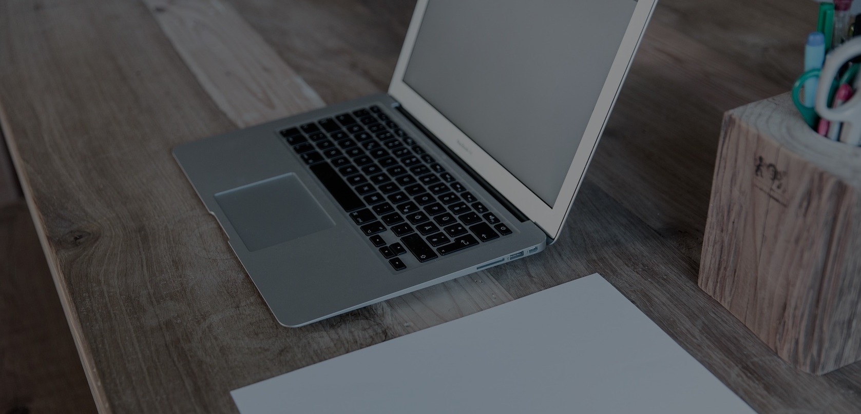 MacBook being used to write code in coffee shop style environment